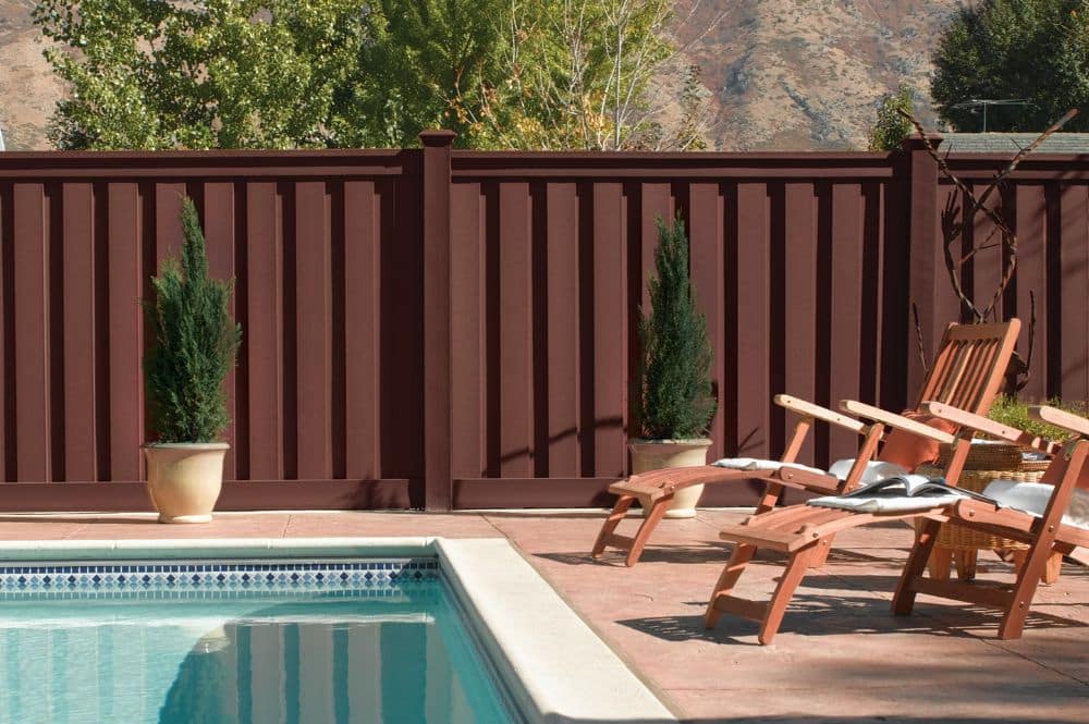 A backyard with a pool surrounded by eco-friendly fencing gives your home security and privacy.